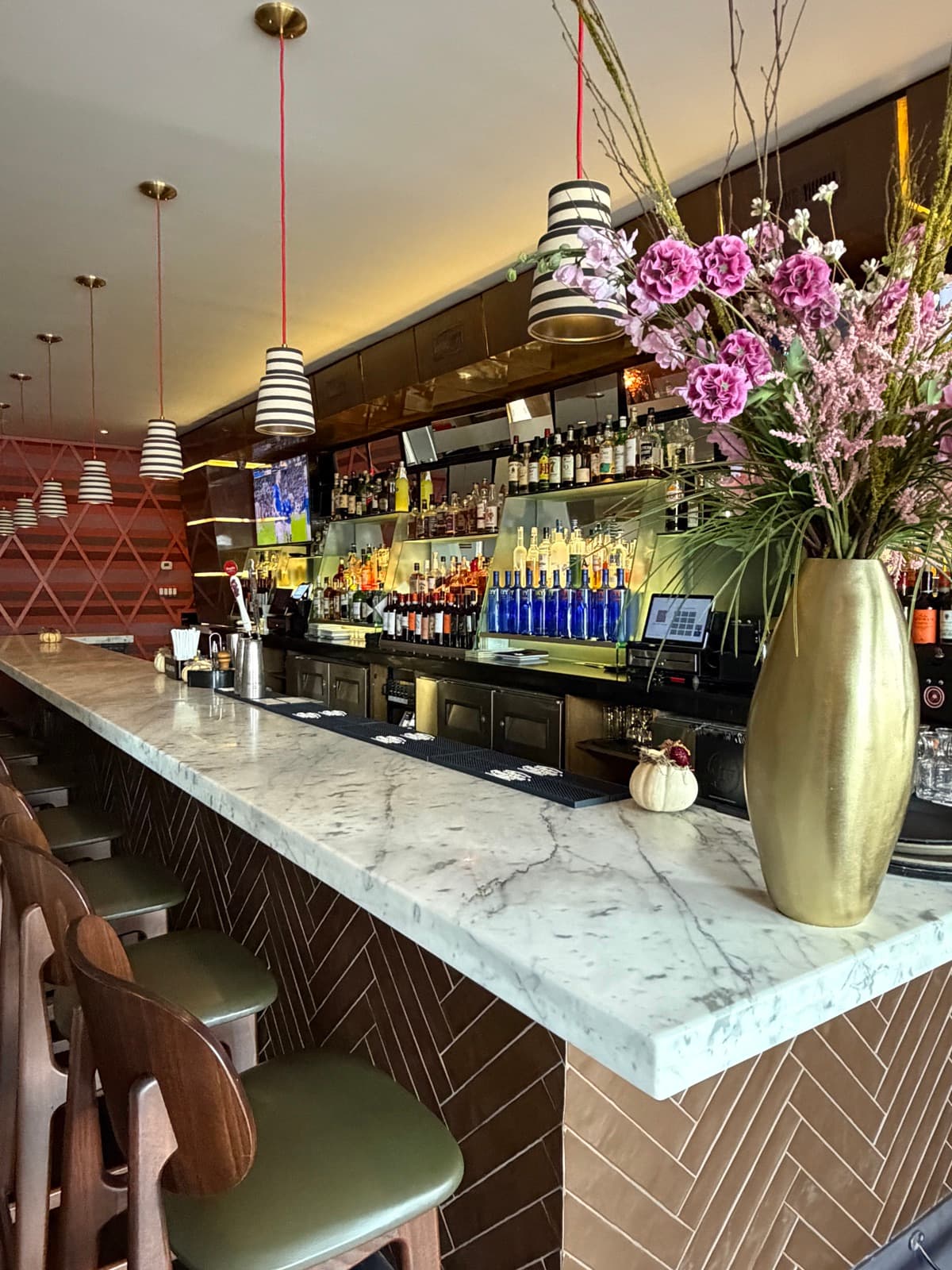 Bar area with hanging plants and warm lighting